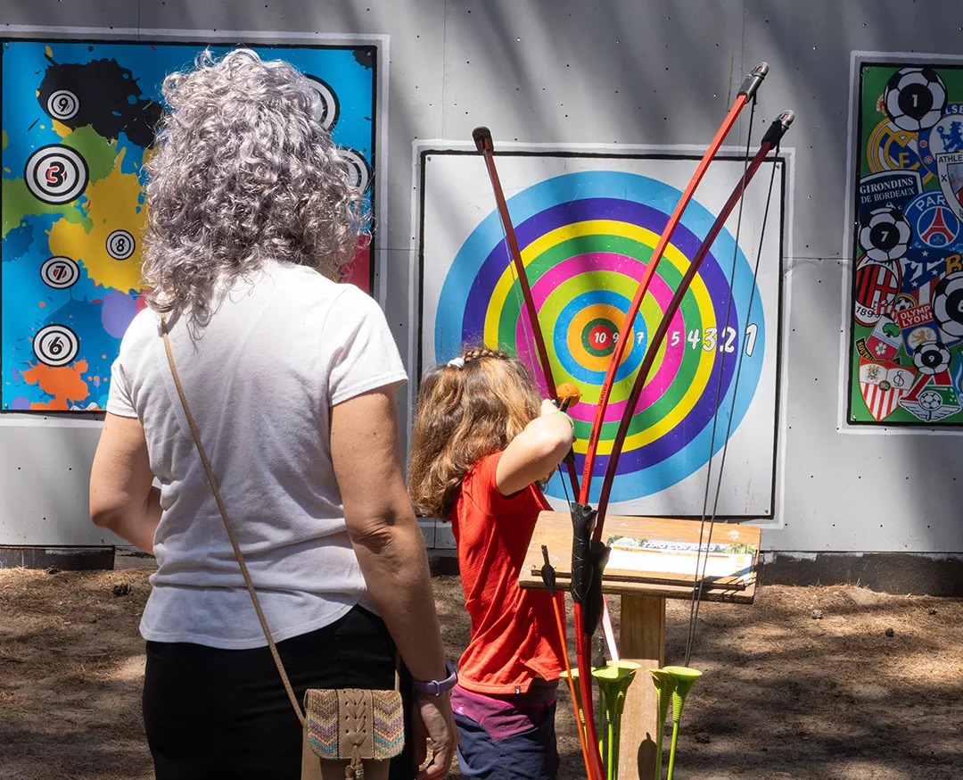 family practicing archery together at Bosc Aventura Salou
